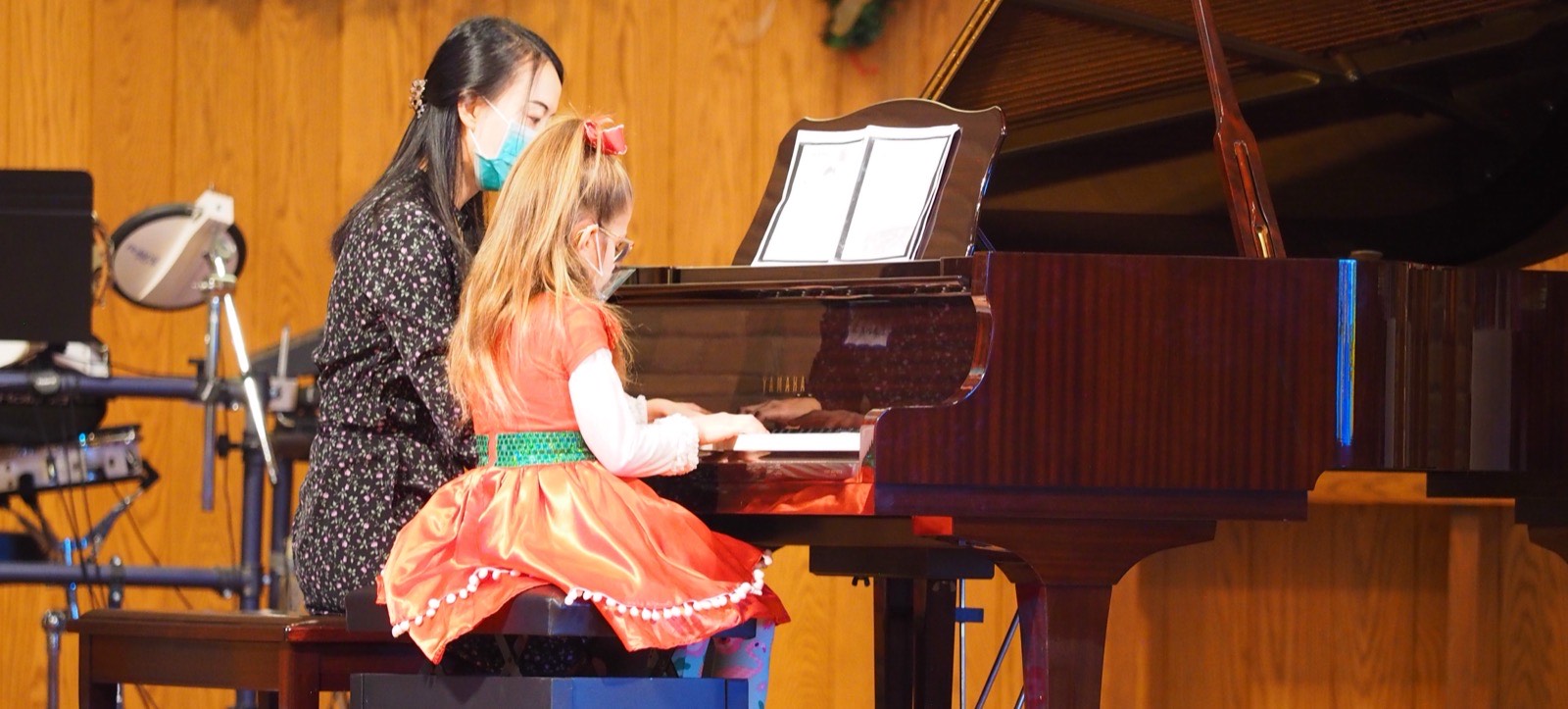 Student playing piano during a private lesson